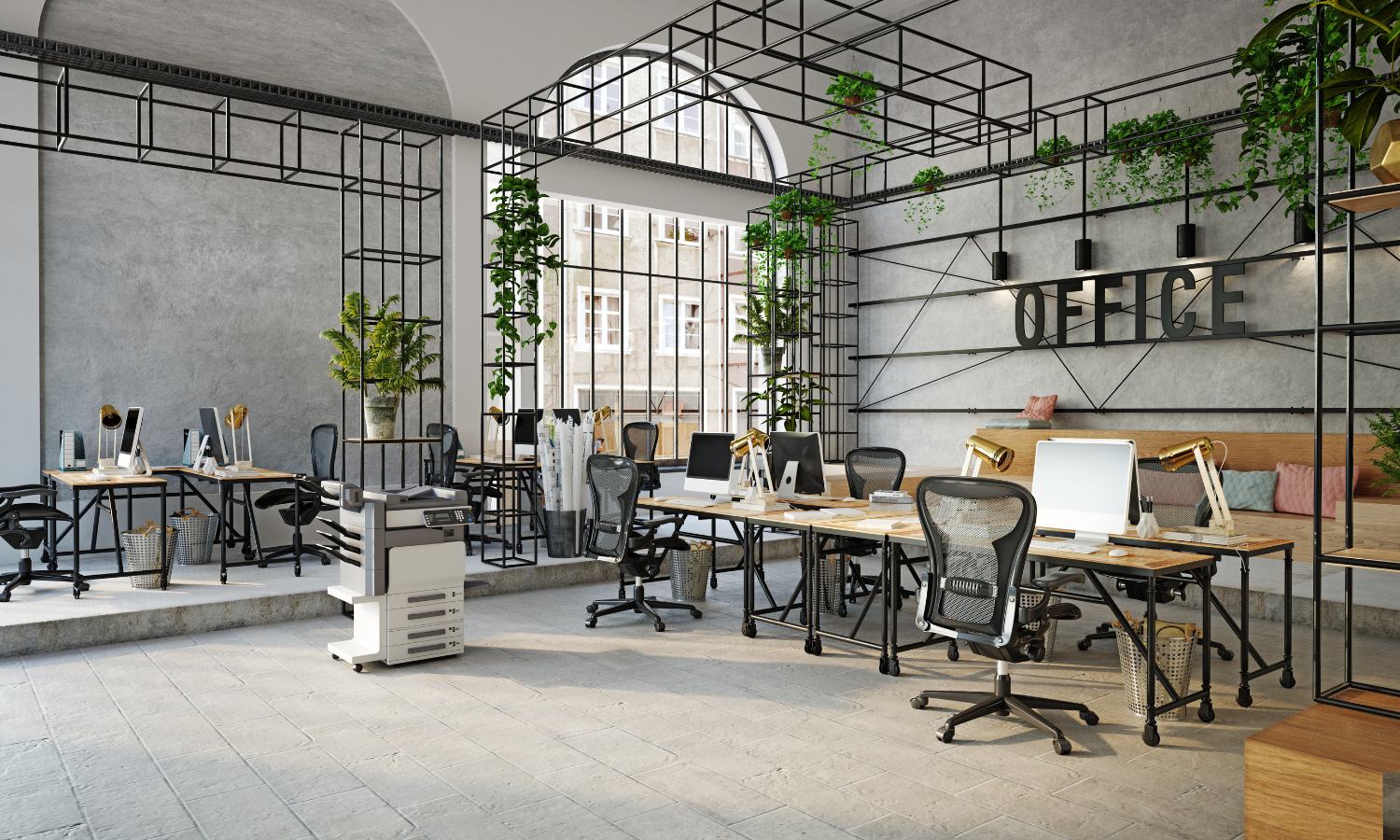 Image shows the interior of a bright, modern office space with floor to ceiling arched window. Black metal gridwork contains shelving and plants while providing a simple room border. Wood desktops on wheels become computer workstations. Each station has a well coordinated mesh and metal ergonomic office chair.