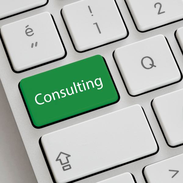 A close up of a QWERTY keyboard. The caps lock key has been replaced by a green key that says "consulting."