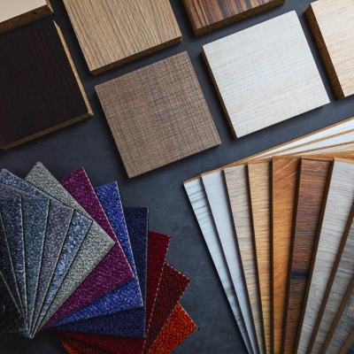 Image shows carpet tile, laminate flooring, and wood flooring swatches.