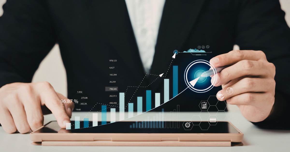 image: torso and hands of man using tablet with stylus as data insights pop up in 3D from the tablet