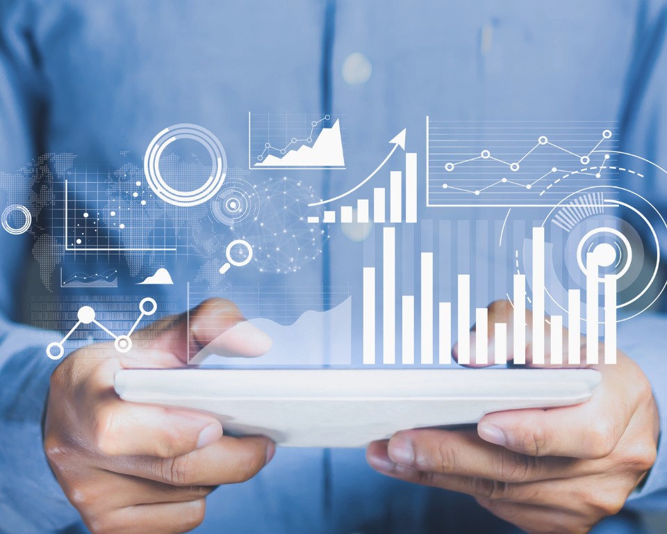 Data insights digitally visualized expanding from tablet in man's hands.